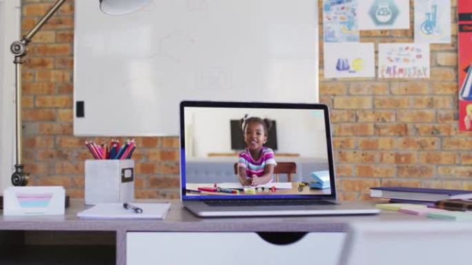 非裔美国女学生在学校桌子上的笔记本电脑上进行视频通话的网络摄像头视图