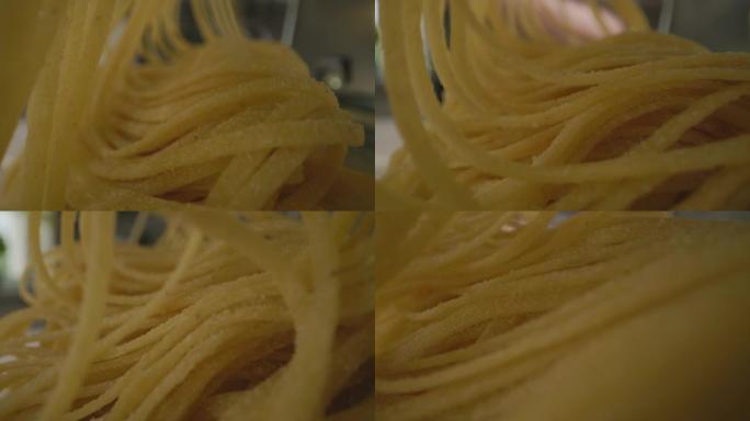 厨师使用面食制作机从面食中制作面食的特写镜头