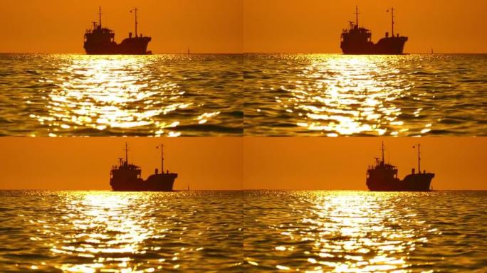 日落时海上货船的剪影