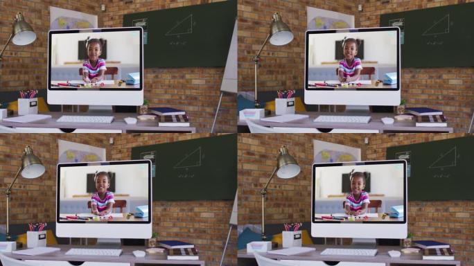 非裔美国女孩在桌子上的计算机屏幕上上在线学校课