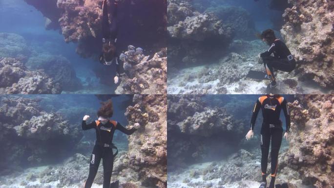 水下模型自由潜水员在红海干净透明的蓝色水中游泳。