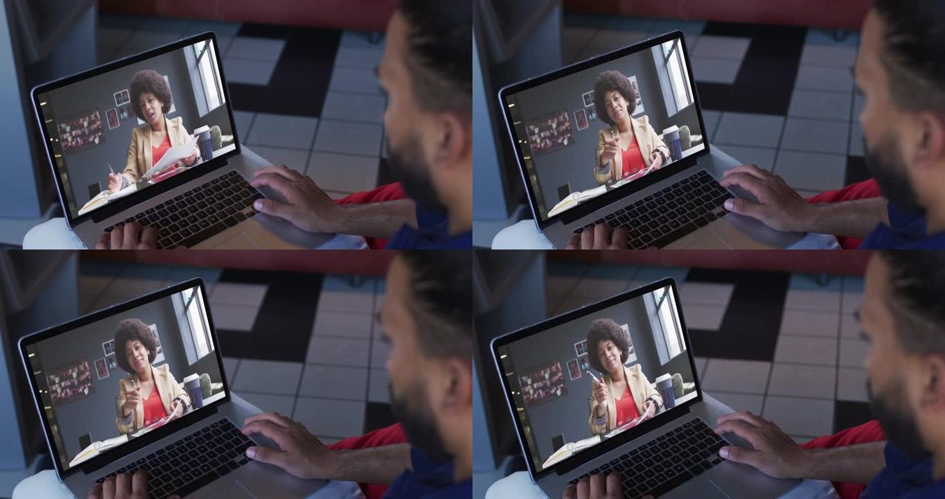 非裔美国商人使用笔记本电脑与女同事进行视频通话