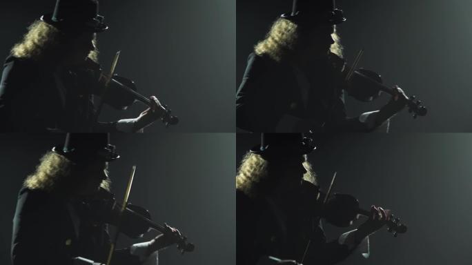 小提琴家音乐家演奏乐器。一个穿着黑色西装和爱尔兰帽子的男人的剪影，用小提琴演奏旋律。带有霓虹灯的黑烟