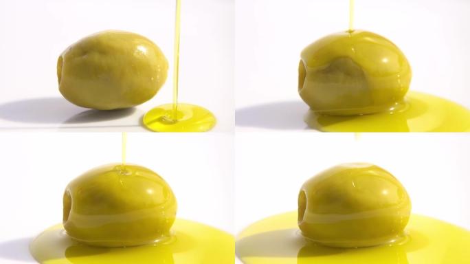 将植物油流倒入绿色的橄榄中。健康烹饪。地中海食品