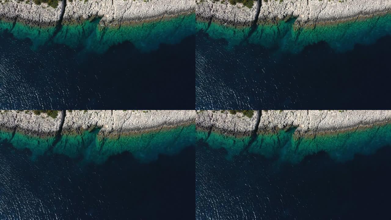 带有一个小岩石岛的蓝色田园诗般的大海的无人机视图