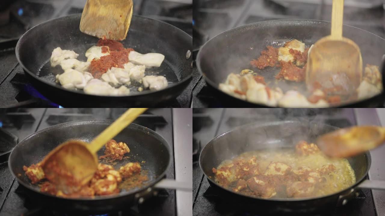 厨师在热锅里煎辣椒酱和鸡肉。