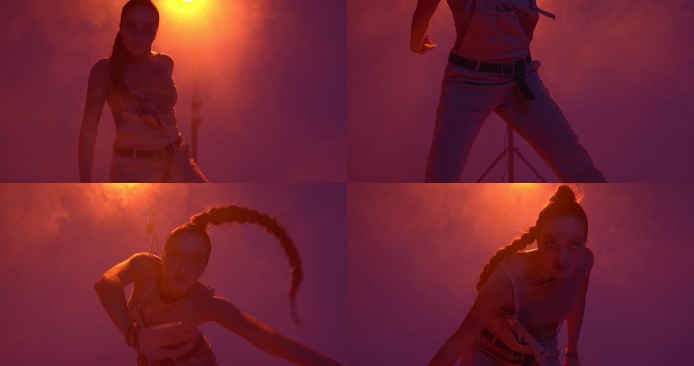 酷年轻的混血女孩在烟雾中聚光灯下跳舞热舞或嘻哈。表情和节奏