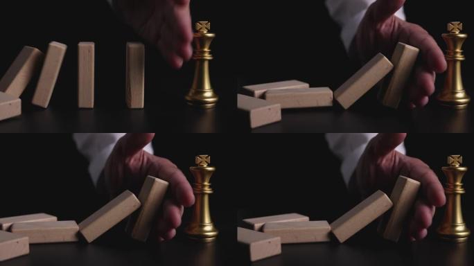 4k视频慢动作特写手停止多米诺骨牌效果，让王者象棋倒下。