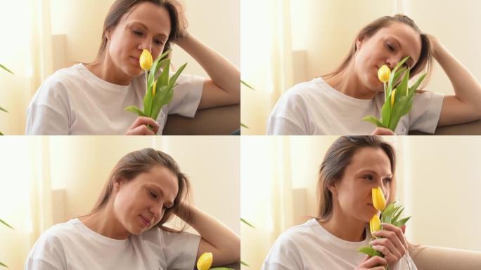 迷人的白人妇女微笑着享受黄色郁金香的气味在家庭内部。母亲节，3月8日和生日概念。