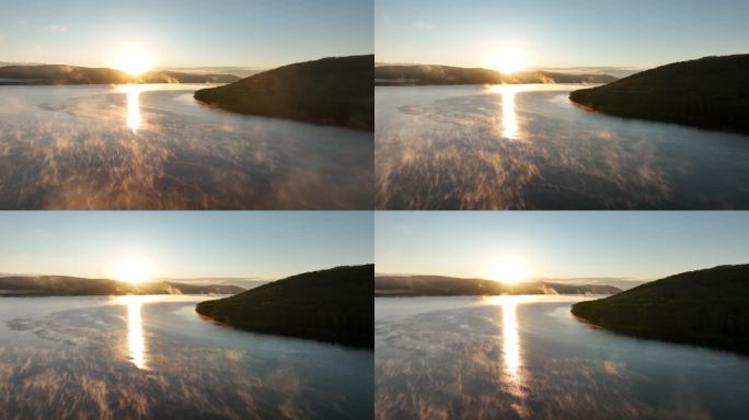 航拍晨雾缭绕的朝阳湖泊