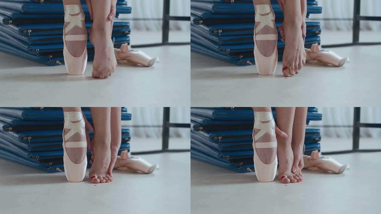 芭蕾舞女演员在训练后按摩受伤的脚