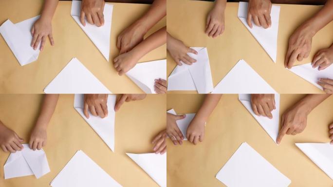 妈妈和孩子的近距离学习在家折叠日纸折纸。折纸艺术。顶视图
