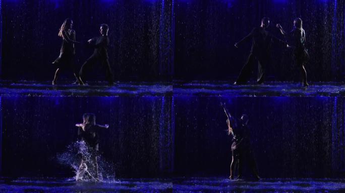 舞厅舞者在倾盆大雨中跳舞热情的拉丁美洲bachata舞蹈。一对年轻夫妇的剪影，穿着湿衣服，黑色工作室