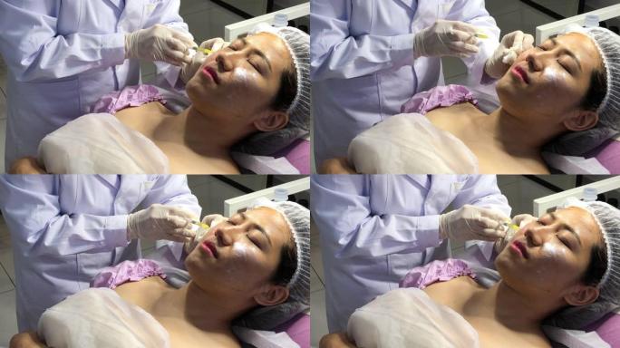 在面部美容院接受面部注射治疗的亚洲中国女性顾客