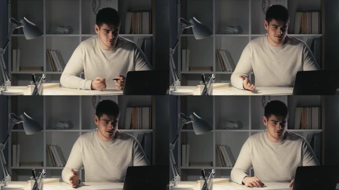 视频通话夜间工作男经理使用笔记本电脑