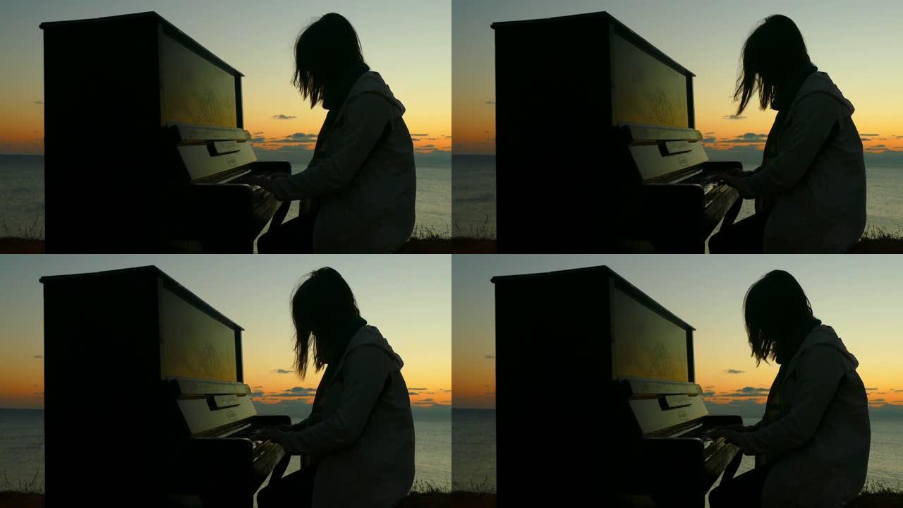 日落时弹钢琴的女孩的剪影
