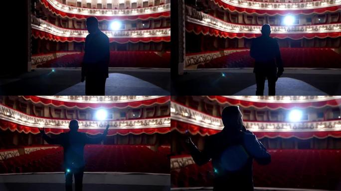 经典戏剧舞台上的演员。表演期间，男子在聚光灯下讲话。后视图视频。