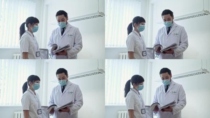 亚洲男医生女护士讨论病人病例