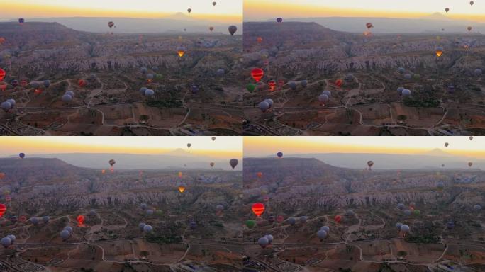 土耳其，卡帕多西亚，2021年10月12日: 鸟瞰热气球在爱情谷，格雷梅，内夫希尔，日出上空飞行的早