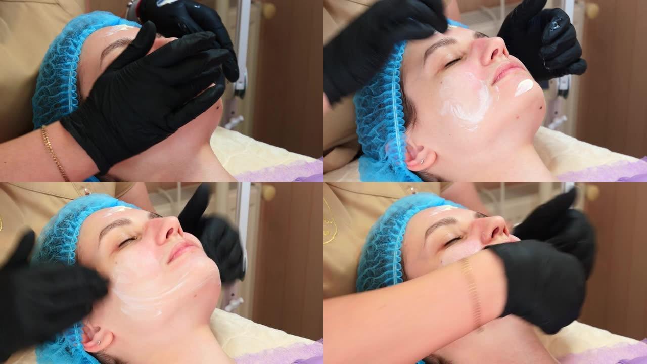 特写，医用手套的美容师在脱皮后将化妆霜或防晒霜均匀地涂在女性脸上。护肤和防晒概念。美容院美容