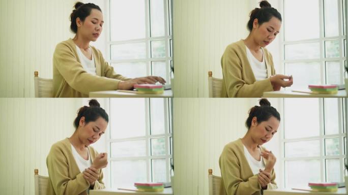 亚洲女性按摩手缓解疼痛的特写镜头腕管症状和慢性病保健概念