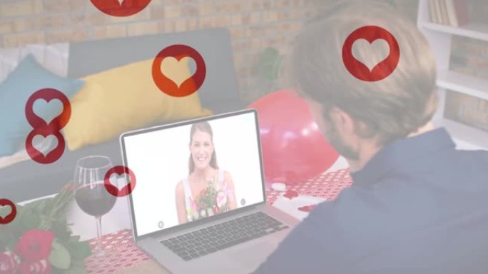 在笔记本电脑上进行视频通话时，漂浮在白人男子上方的多个红心图标