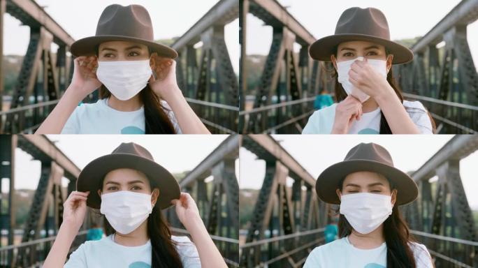 特写美女在桥上戴着外科口罩，安全出行理念。