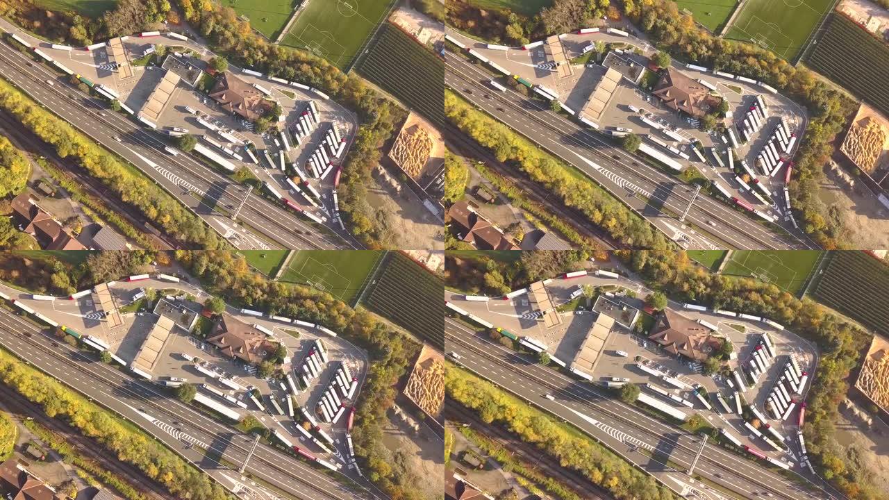 高速公路州际公路的俯视图，交通快速，停车场停放卡车。