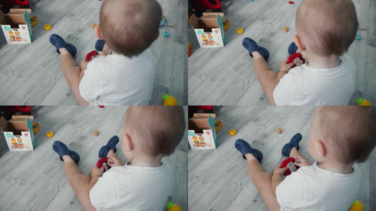 孩子在地板上玩玩具。摄像机将从后面拍摄。