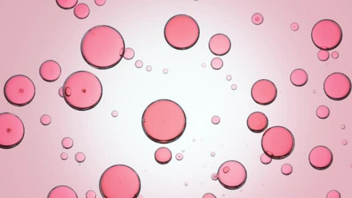 粉色液体被注入带有粉色气泡的透明液体中