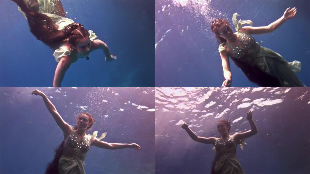 红海珊瑚背景下的仙女服装水下模型自由潜水员。