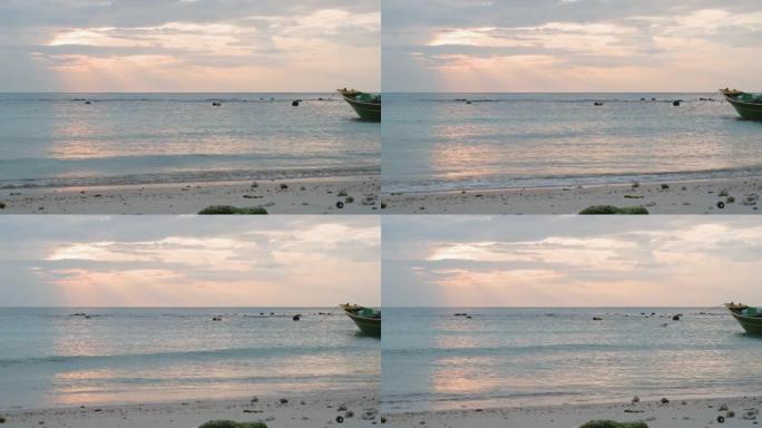 清晨日出时沙滩上的海水波浪天空自然背景长船尾