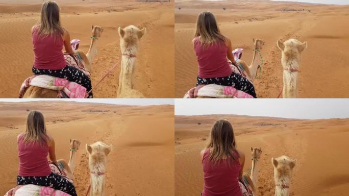 沙漠中的女子驼背骑行