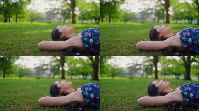 年轻女子躺在草地上放松