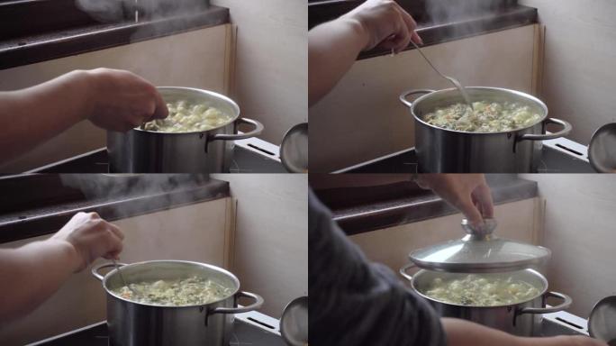 用兔肉，菠菜和土豆炖煮第一次婴儿喂养。业余家常菜放在炉子上的锅里。
