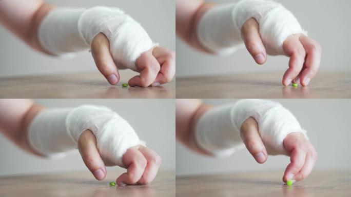 断手绷带试图服用止痛药。受伤后的压力和疼痛