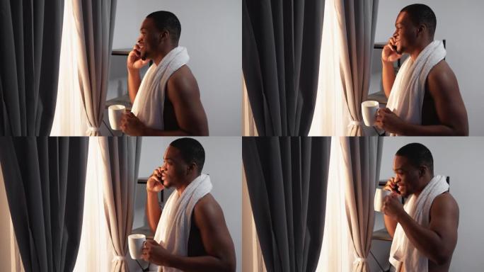 早上打电话放松的非洲男子在电话上讲话
