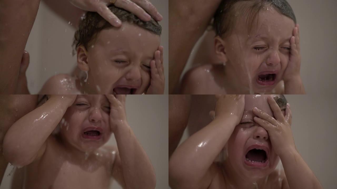哭泣的婴儿在淋浴时洗头，洗头时眼睛发痒。心烦意乱的孩子哭泣