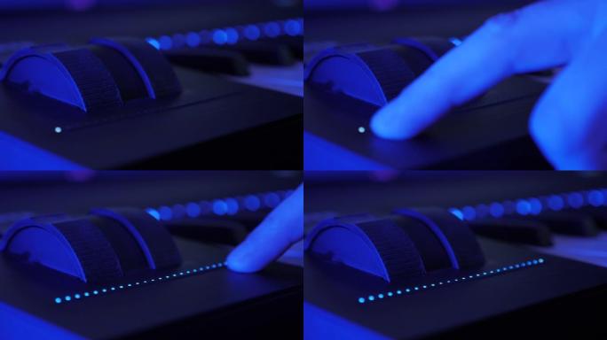 触摸栏光标增加电子钢琴键盘上的音频音量。用发光二极管灯触摸音量条的人。专业音乐唱片工作室。在排练工作