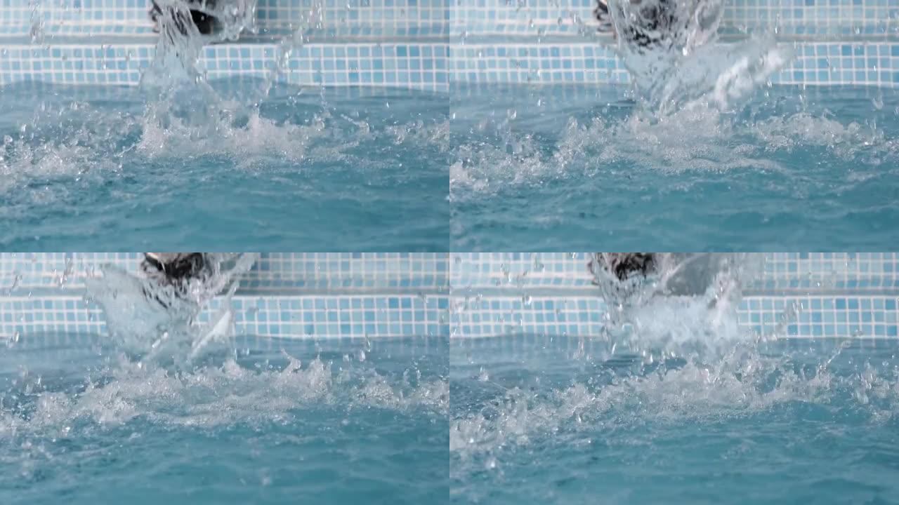 水溅入游泳池的慢动作，水滴从水面喷出