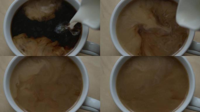 将黑咖啡倒入杯中。新鲜的早晨倒在红茶上特写。选择性聚焦。俯视图将牛奶倒入一杯热咖啡或茶中。