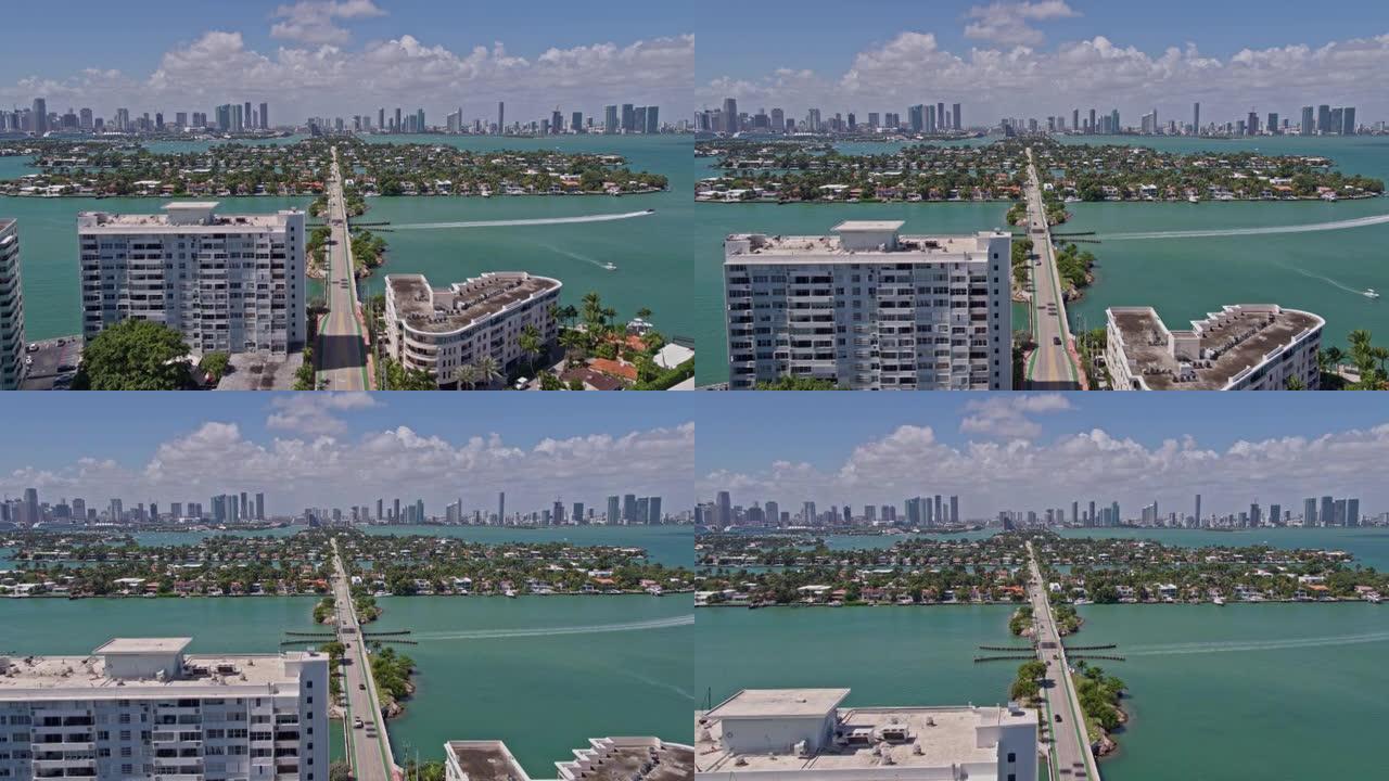 在刮风，阳光明媚的日子里，沿着威尼斯之路，在威尼斯群岛上空，俯瞰迈阿密市中心的空中广角视图。无人机制