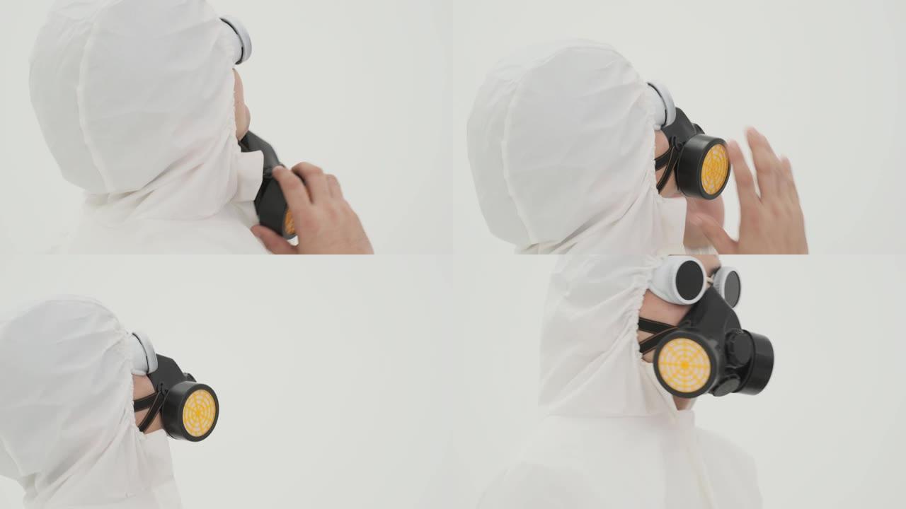 穿着防护服的男人给自己戴上防毒面具的特写镜头。以白色背景拍摄。