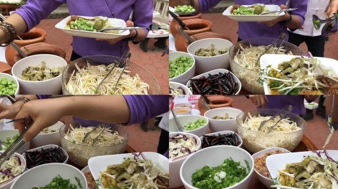 午餐休息教育人们和学生在泰国传统服装排队等待食物饭或米粉蔬菜泰国北方风格。户外餐饮餐饮派对理念。