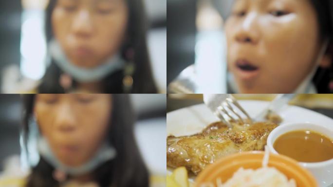 亚洲女孩在餐厅吃烤鸡排与家庭，生活方式的概念。