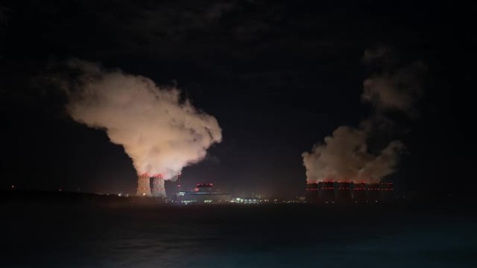 核电站的蒸汽管冷却塔在夜间排放蒸汽。核电站在夜间运行。能源。核燃料。提供电力和热量