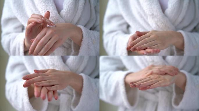 女人用保湿抗皱霜涂抹双手