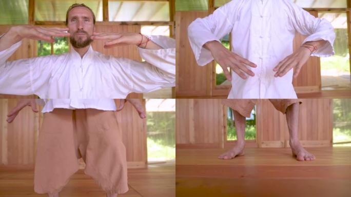 大胡子高加索男子穿白色衣服练习气功太极拳前的注意力和呼吸