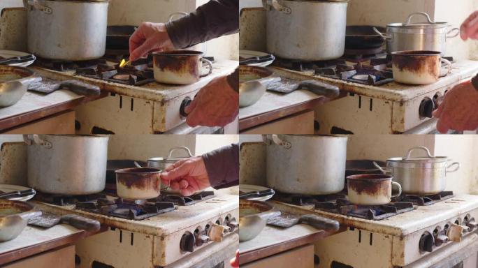 展示穷人生活条件的人。厨房配有老式菜肴和用于烹饪的煤气炉。