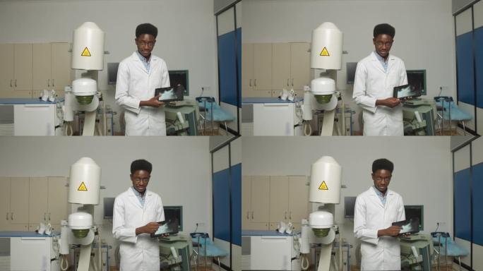 身着白色制服和眼镜的年轻非洲裔美国男子医生的特写肖像，手持数字平板电脑，在泌尿外科医疗中心现代超声波
